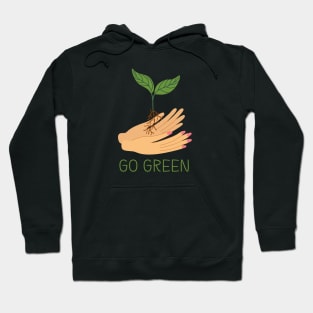 Hands holding green sprout. Hoodie